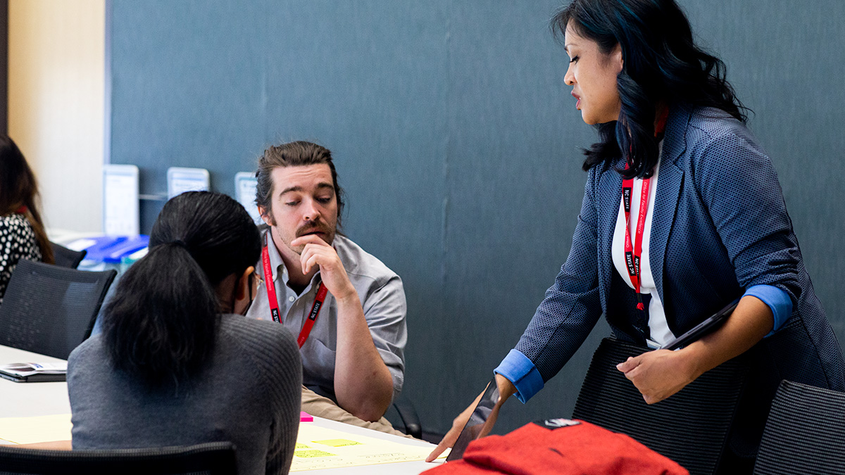 DELTA staff work with instructors in a workshop.